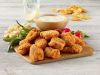 Buffalo chicken breast bites. Fully cooked chicken breast chunks, breaded and seasoned